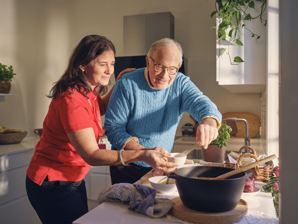 caregiver helping client in the kitchen