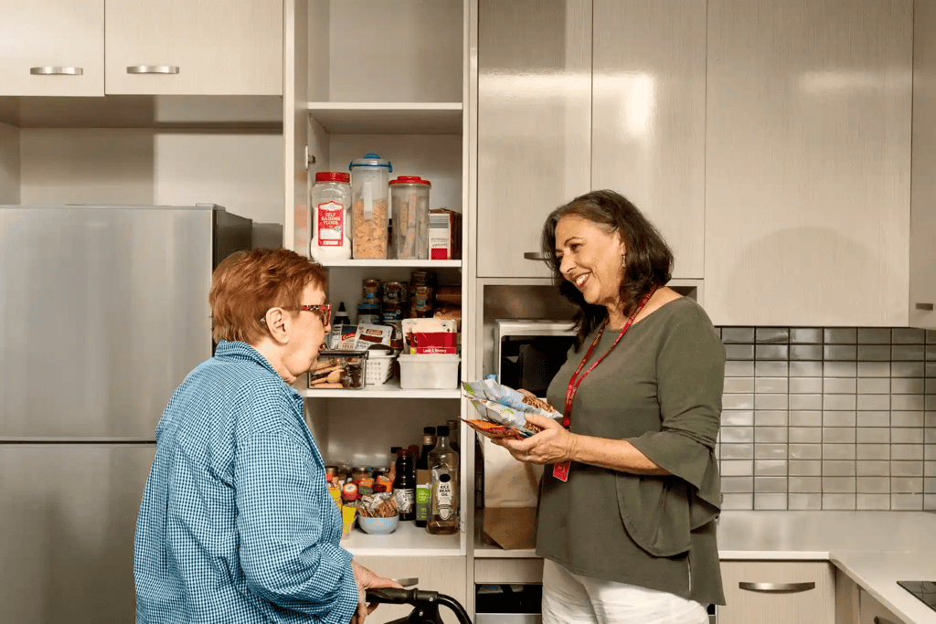 caregiver helping client organise the pantry